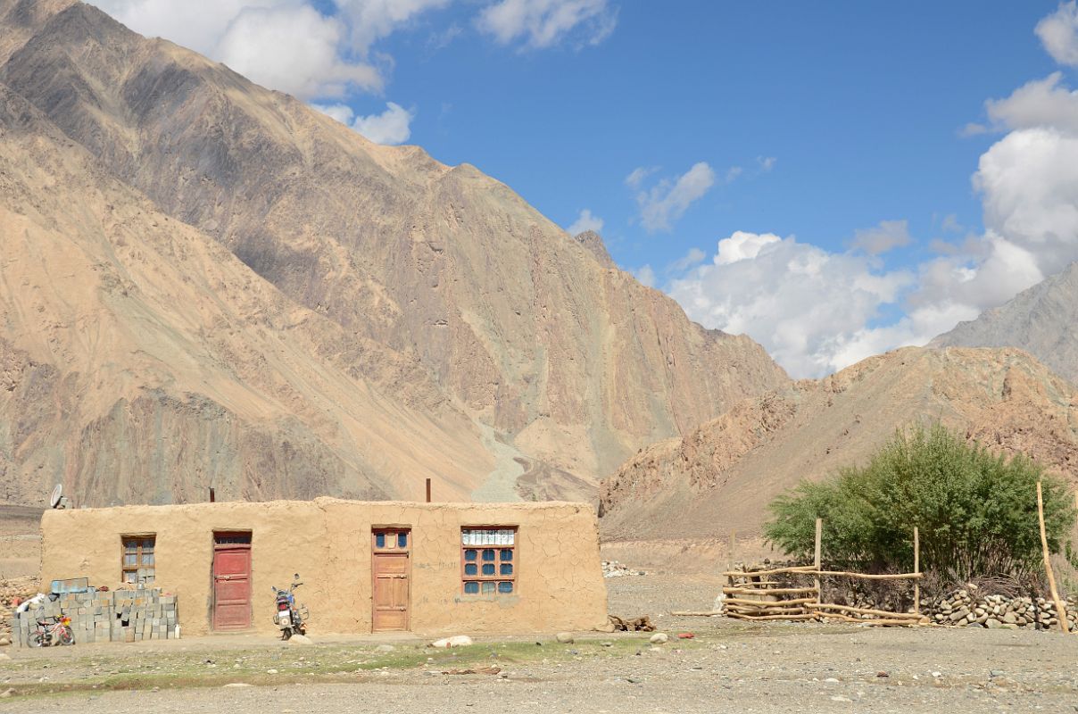 21 Motorcycle Outside Mudbrick House In Yilik Village On The Way To K2 China Trek